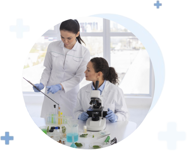 Female Scientists Working in Laboratory with Microscope and Test Tubes Female scientists using microscope and test tubes in modern science laboratory